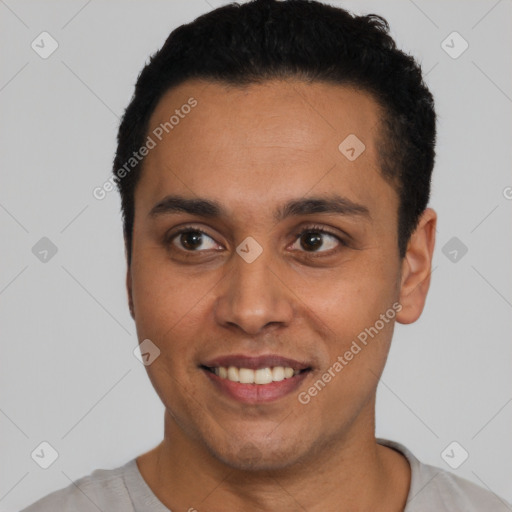 Joyful latino young-adult male with short  black hair and brown eyes