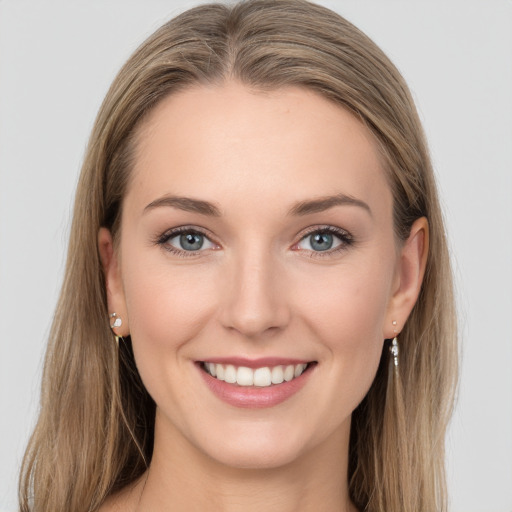 Joyful white young-adult female with long  brown hair and grey eyes