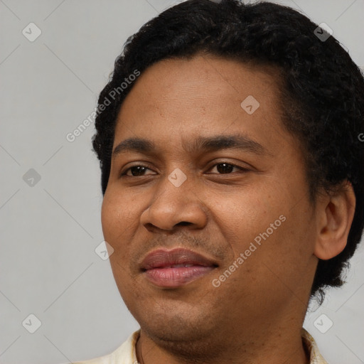 Joyful latino young-adult male with short  black hair and brown eyes