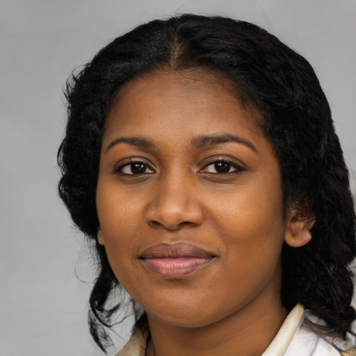 Joyful black young-adult female with medium  black hair and brown eyes