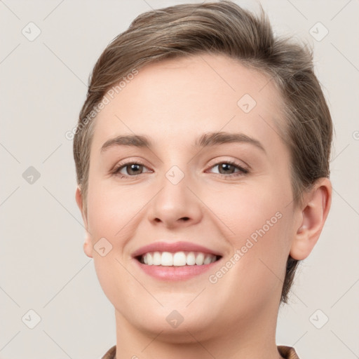 Joyful white young-adult female with short  brown hair and grey eyes