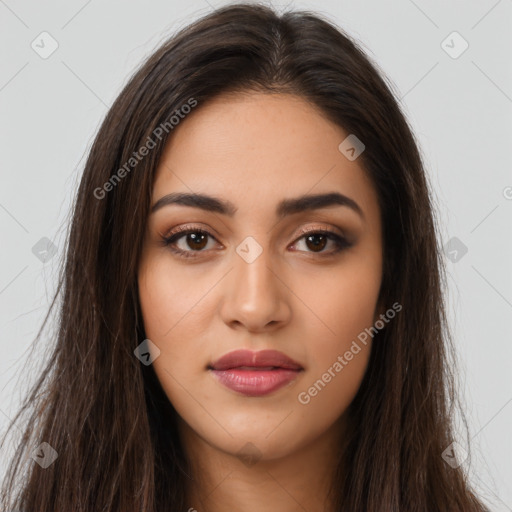 Joyful latino young-adult female with long  brown hair and brown eyes