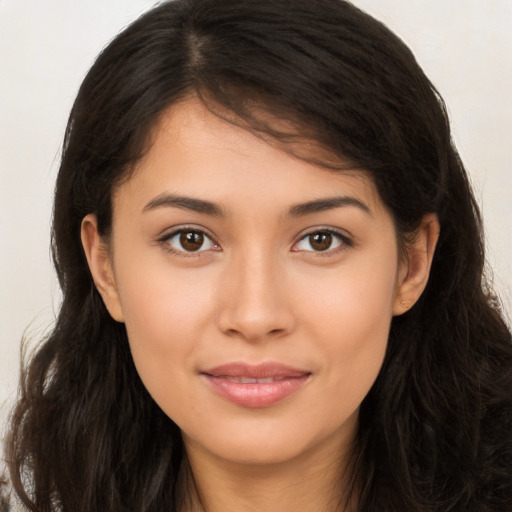 Joyful latino young-adult female with long  brown hair and brown eyes