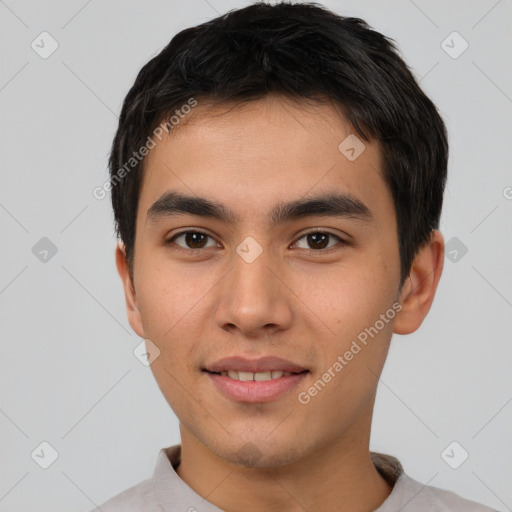 Joyful asian young-adult male with short  brown hair and brown eyes