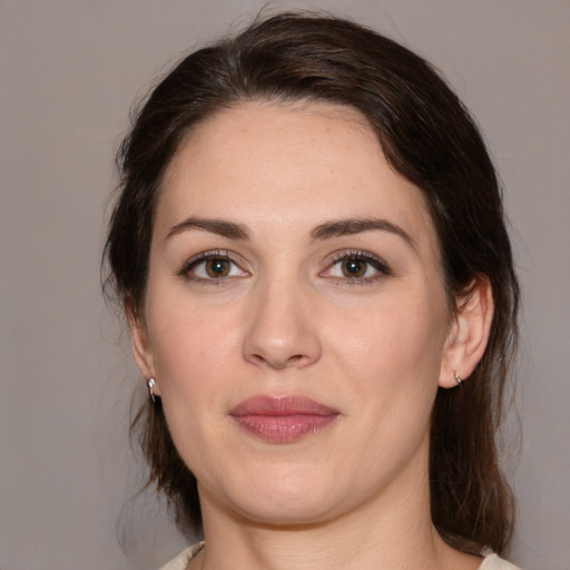 Joyful white young-adult female with medium  brown hair and brown eyes