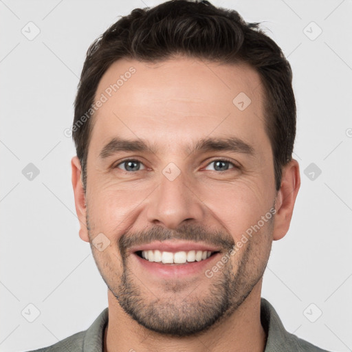 Joyful white young-adult male with short  brown hair and brown eyes