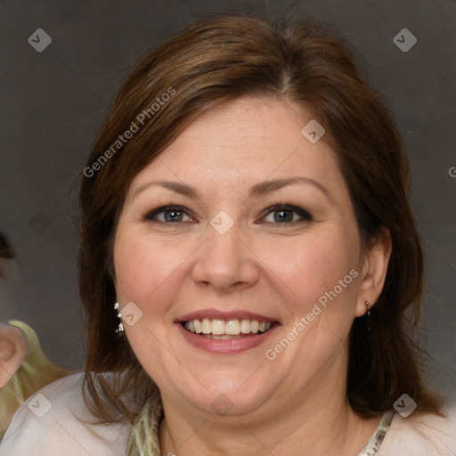 Joyful white adult female with medium  brown hair and blue eyes