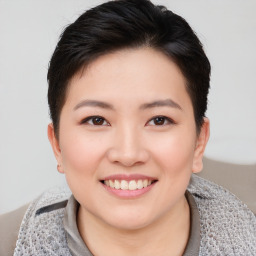 Joyful asian young-adult female with short  brown hair and brown eyes