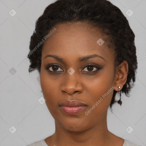 Joyful black young-adult female with short  black hair and brown eyes