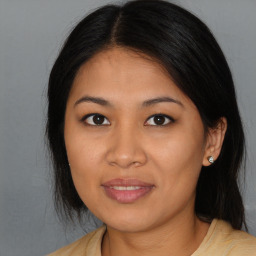 Joyful asian young-adult female with long  brown hair and brown eyes