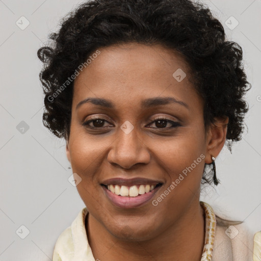 Joyful black young-adult female with short  brown hair and brown eyes