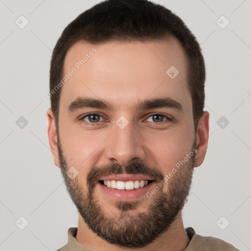 Joyful white young-adult male with short  brown hair and brown eyes