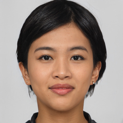 Joyful asian young-adult female with medium  black hair and brown eyes