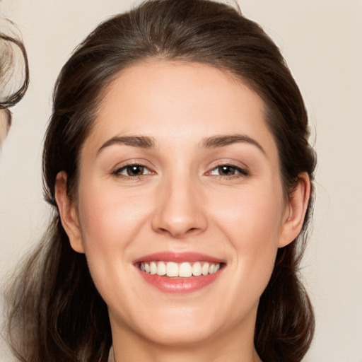 Joyful white young-adult female with medium  brown hair and brown eyes