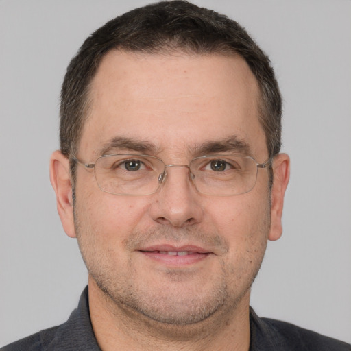 Joyful white adult male with short  brown hair and brown eyes