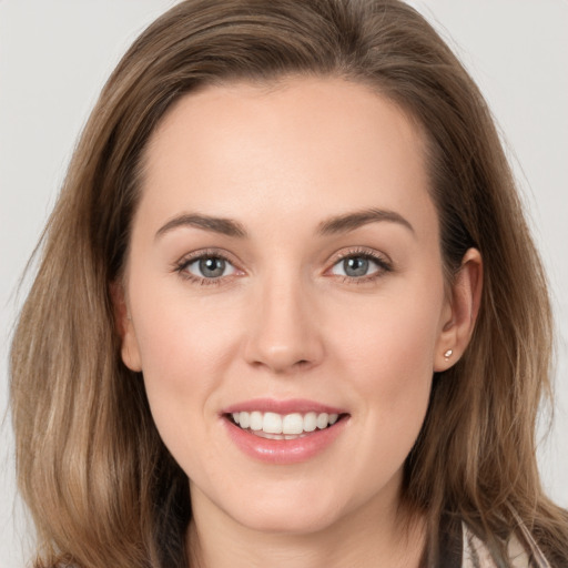 Joyful white young-adult female with long  brown hair and grey eyes