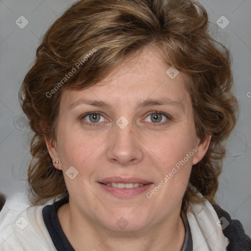 Joyful white adult female with medium  brown hair and blue eyes