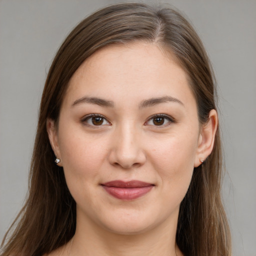 Joyful white young-adult female with long  brown hair and brown eyes