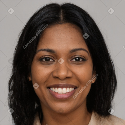 Joyful black young-adult female with long  black hair and brown eyes