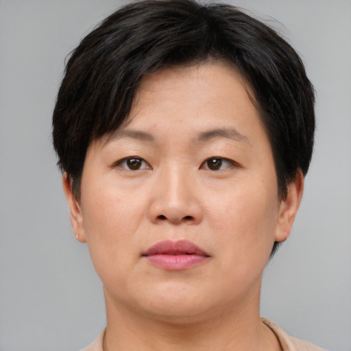 Neutral asian adult female with short  brown hair and brown eyes