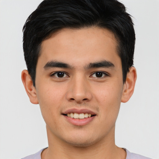 Joyful asian young-adult male with short  brown hair and brown eyes
