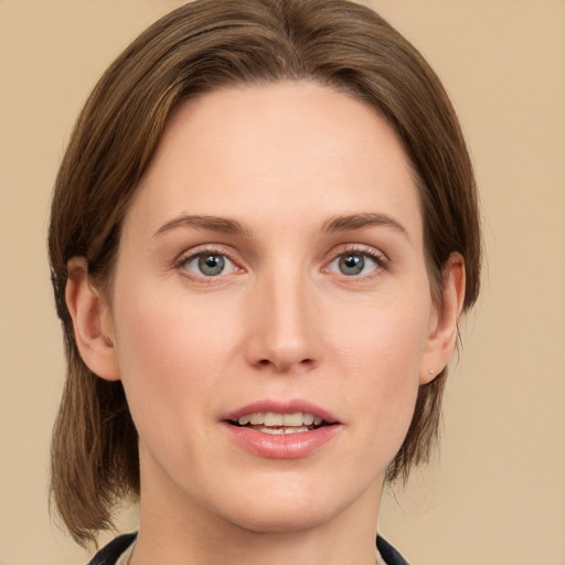 Joyful white young-adult female with medium  brown hair and grey eyes