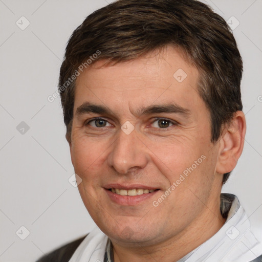 Joyful white adult male with short  brown hair and brown eyes