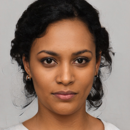 Joyful latino young-adult female with medium  black hair and brown eyes