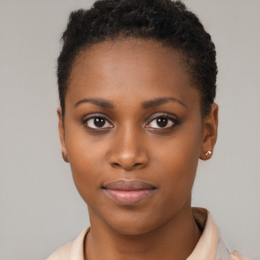 Joyful black young-adult female with short  brown hair and brown eyes