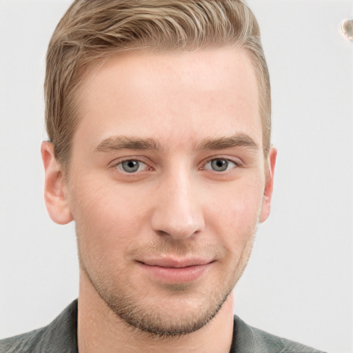 Joyful white young-adult male with short  brown hair and blue eyes