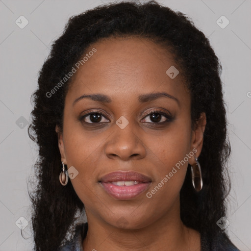 Joyful black young-adult female with long  brown hair and brown eyes