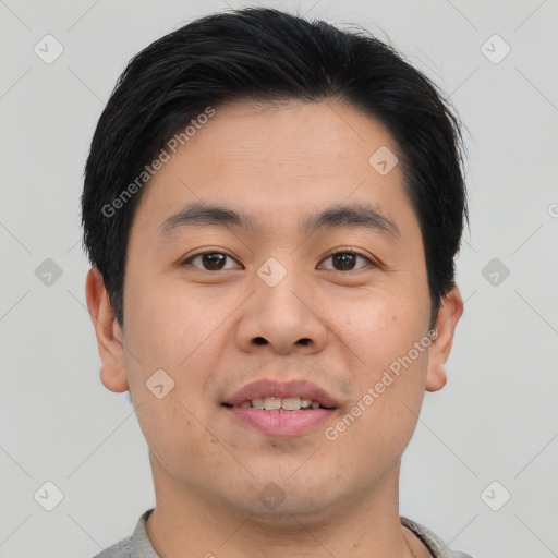 Joyful asian young-adult male with short  brown hair and brown eyes