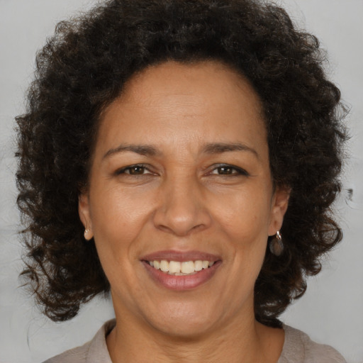 Joyful black adult female with medium  brown hair and brown eyes