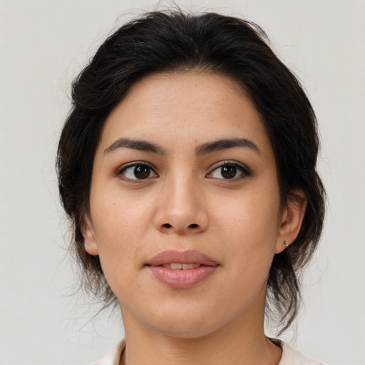 Joyful latino young-adult female with medium  brown hair and brown eyes
