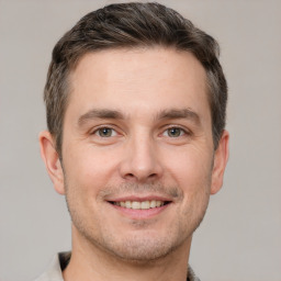 Joyful white young-adult male with short  brown hair and brown eyes