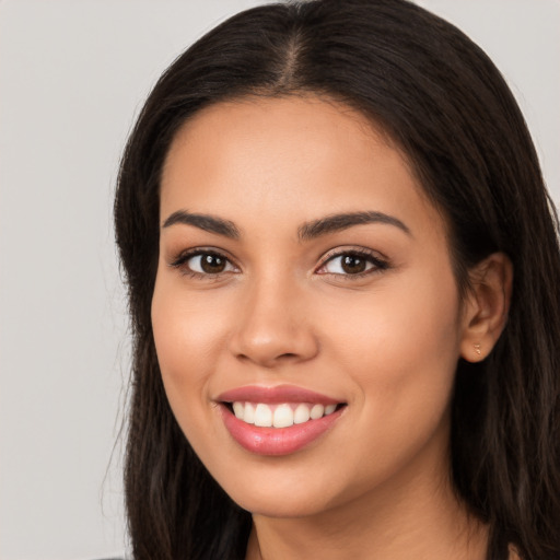 Joyful white young-adult female with long  brown hair and brown eyes