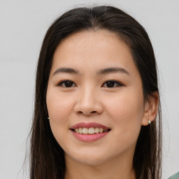 Joyful asian young-adult female with long  brown hair and brown eyes