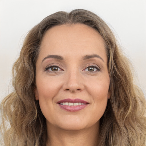 Joyful white young-adult female with long  brown hair and grey eyes