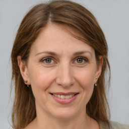 Joyful white adult female with medium  brown hair and grey eyes