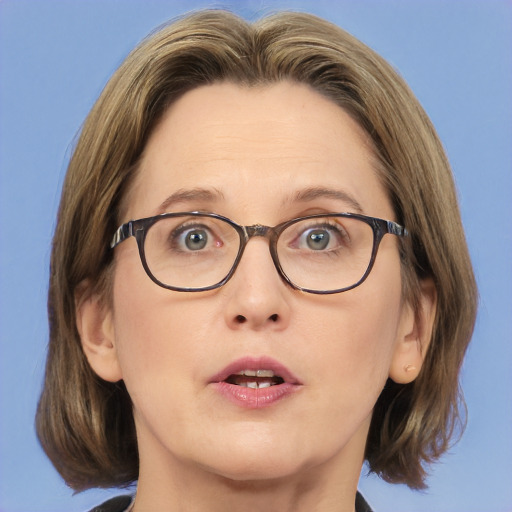 Joyful white adult female with medium  brown hair and blue eyes