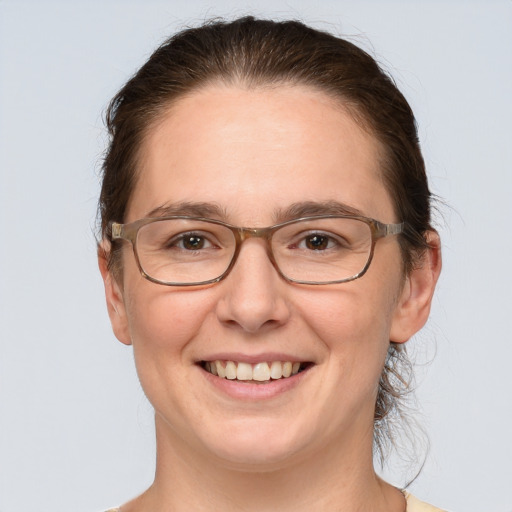 Joyful white adult female with short  brown hair and grey eyes