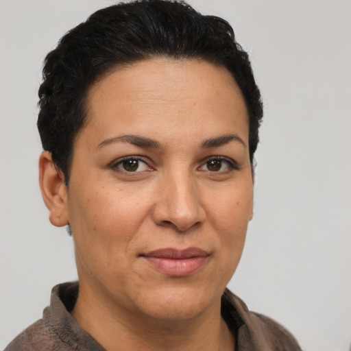 Joyful latino adult female with short  brown hair and brown eyes