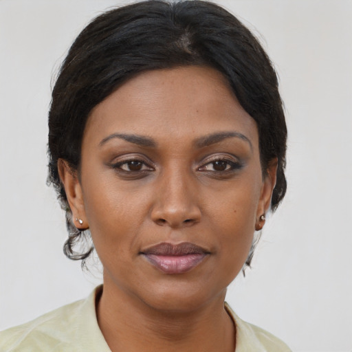 Joyful black young-adult female with medium  brown hair and brown eyes