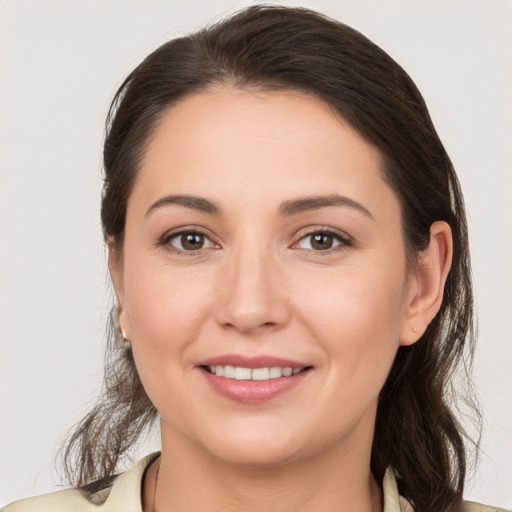 Joyful white young-adult female with medium  brown hair and grey eyes