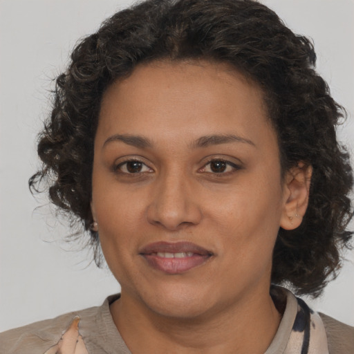 Joyful black young-adult female with medium  brown hair and brown eyes