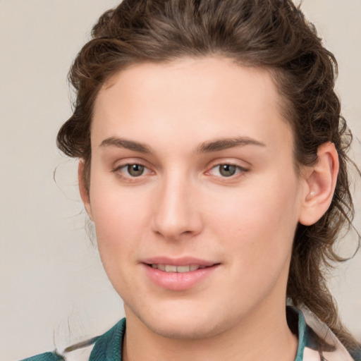 Joyful white young-adult female with medium  brown hair and green eyes