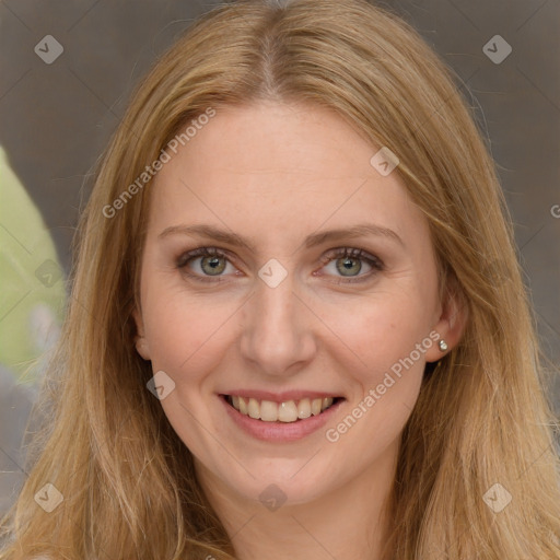 Joyful white adult female with long  brown hair and green eyes