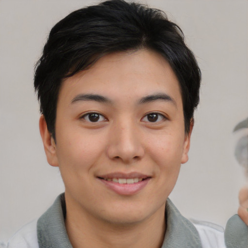 Joyful asian young-adult female with short  brown hair and brown eyes