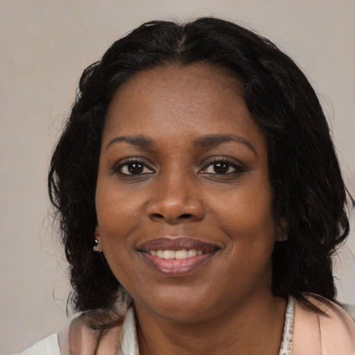 Joyful black young-adult female with medium  brown hair and brown eyes