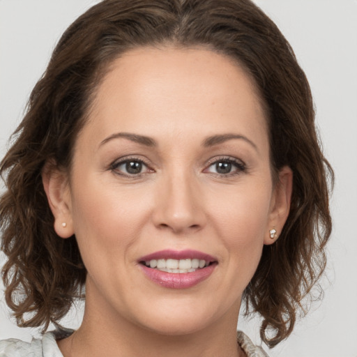 Joyful white young-adult female with medium  brown hair and brown eyes